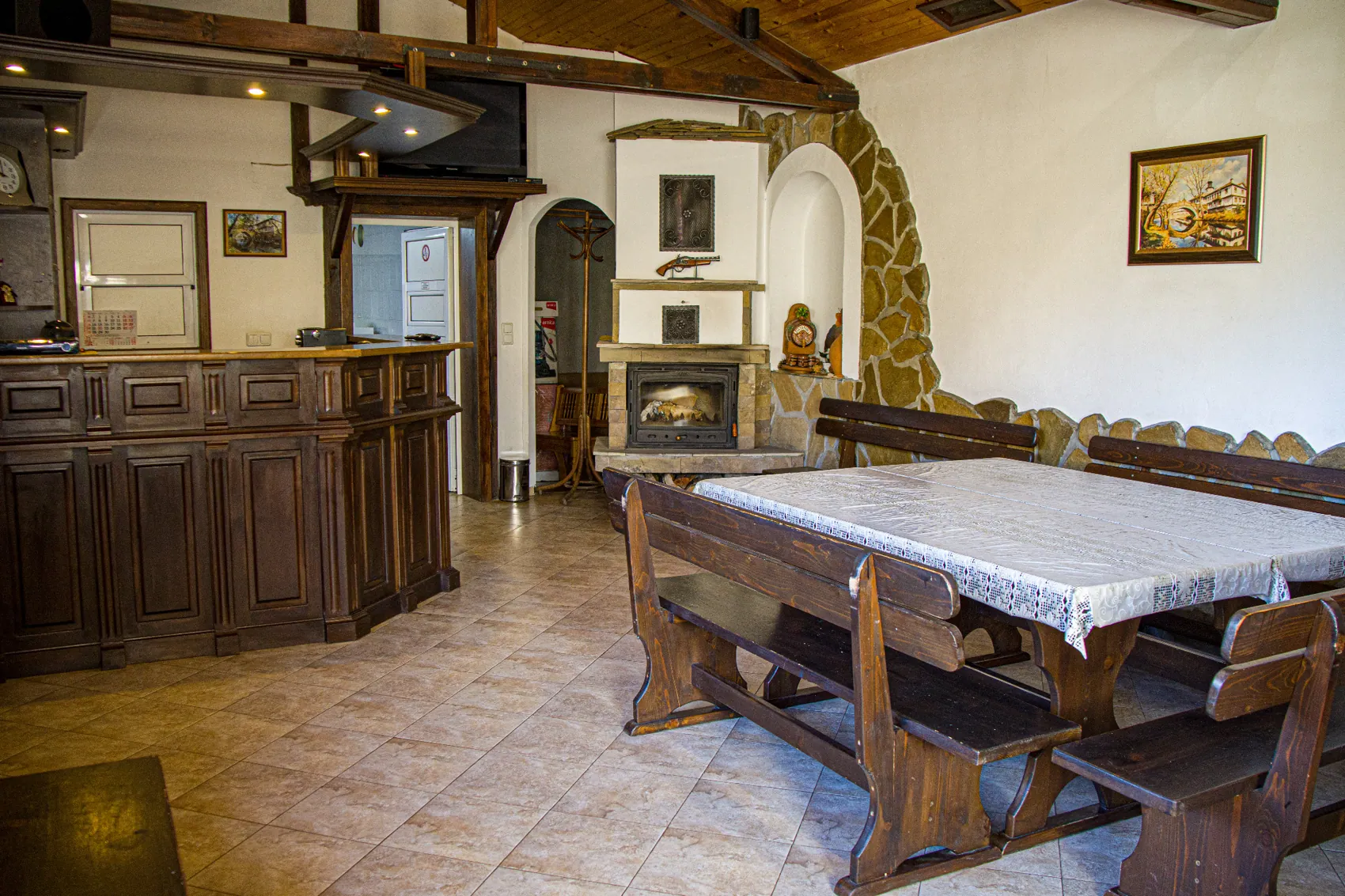 Vasilena Guest House tavern with tables, bar and fireplace